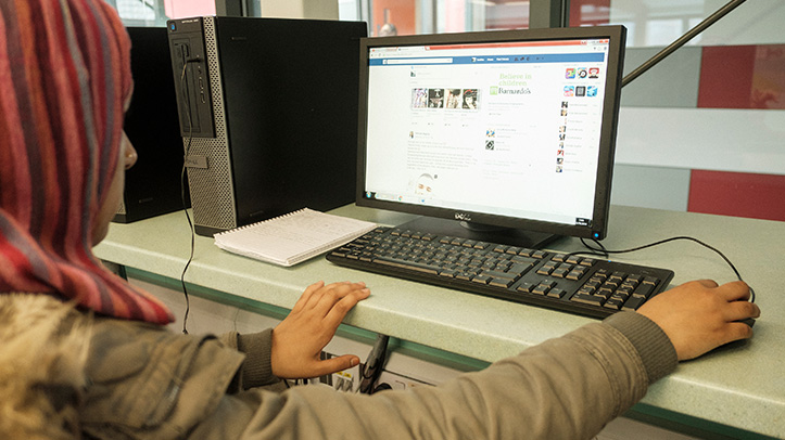 Young person browsing Facebook on their computer
